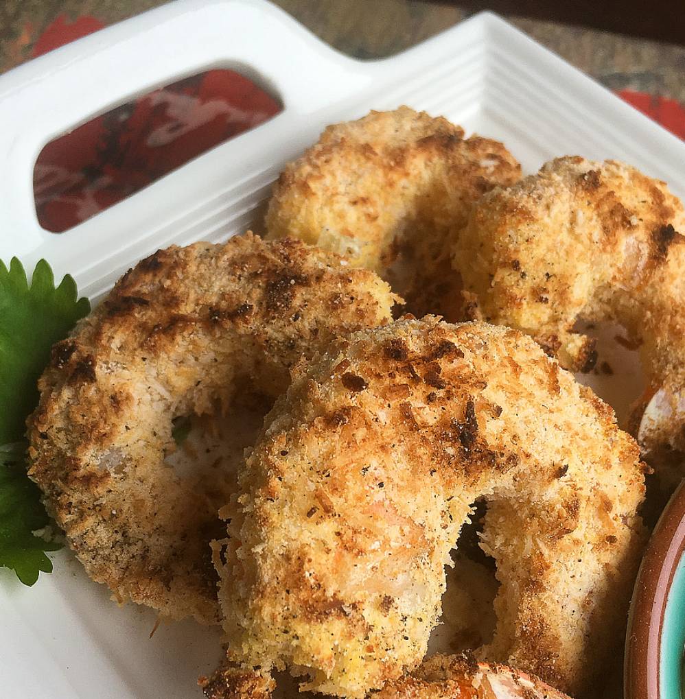 breaded coconut shrimp with a sprig of parsley
