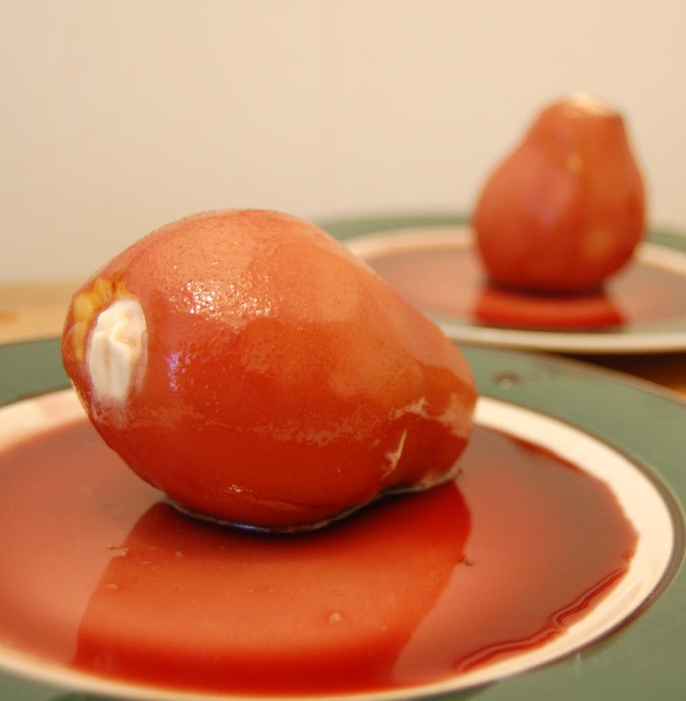 pears poached with red wine on green plates